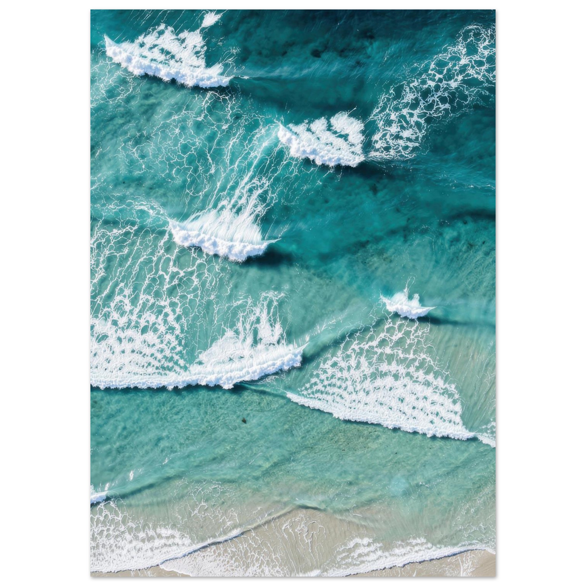 Aerial view of ocean waves with white foam rolling onto a sandy beach in turquoise water.